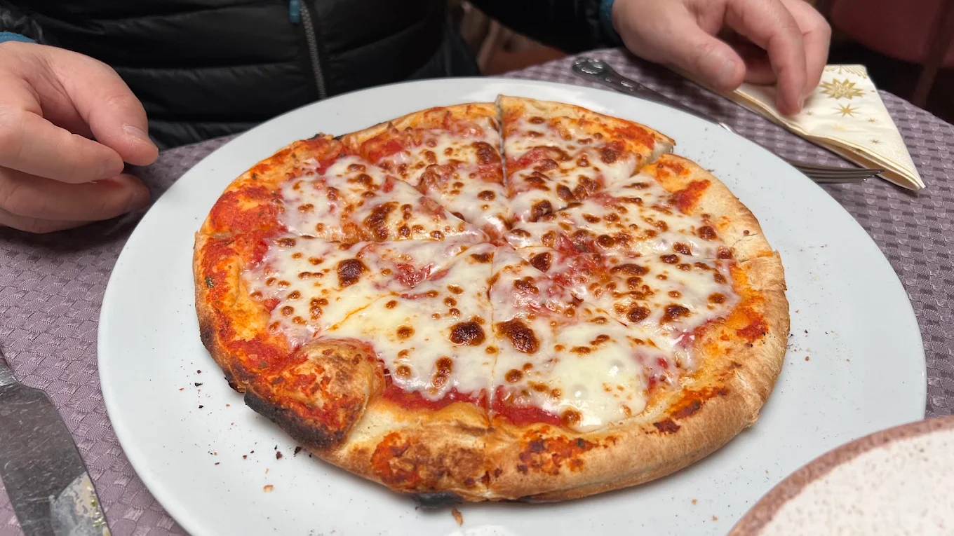 Golden baked pizza with tomato and melted mozzarella at Fabio’s